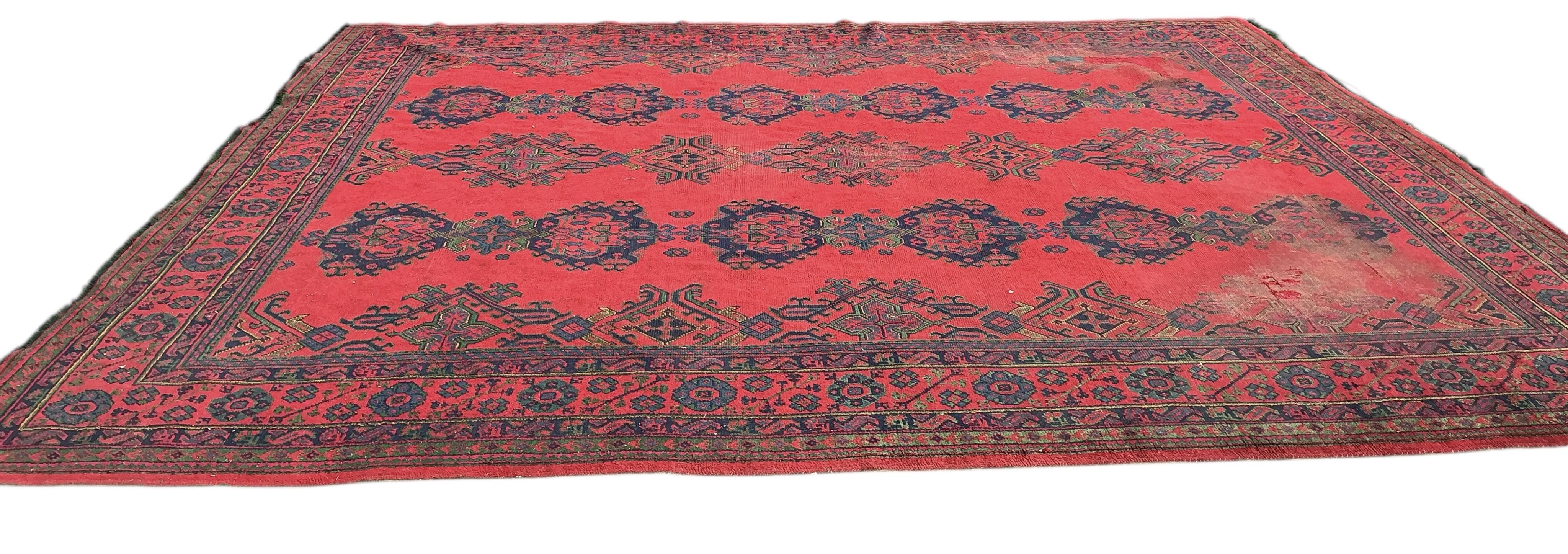 An early 20th century Afghan red ground carpet, 445 x 375cm